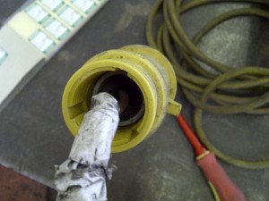 110v electrical adaptor that is damaged and has been repaired with gaffer tape