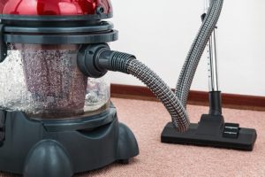 Red vacuum cleaner for cleaning carpets
