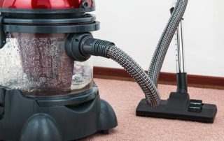 Red vacuum cleaner for cleaning carpets