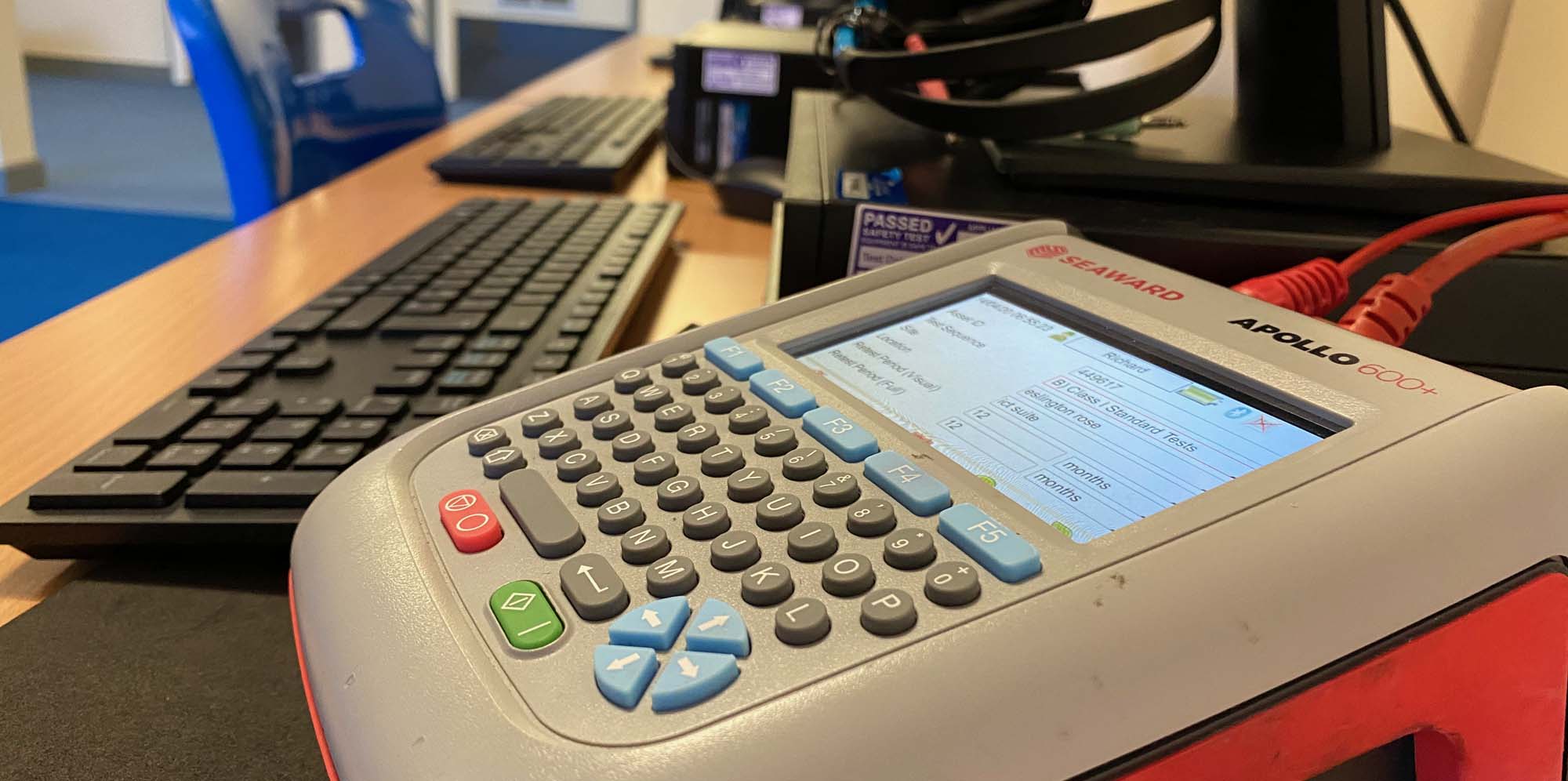 PAT testing machine testing a computer in a school