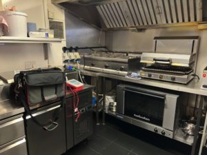 Arlo's Restaurant kitchen in Jesmond, Newcastle upon Tyne, showing ovens, coolers, the grill and fryers