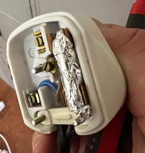 UK Plug where the blown fuse has been wrapped in foil rather than replacing the fuse.