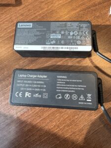Fake LPSU side 2 'Lenovo' laptop chargers - one genuine, one counterfeit.